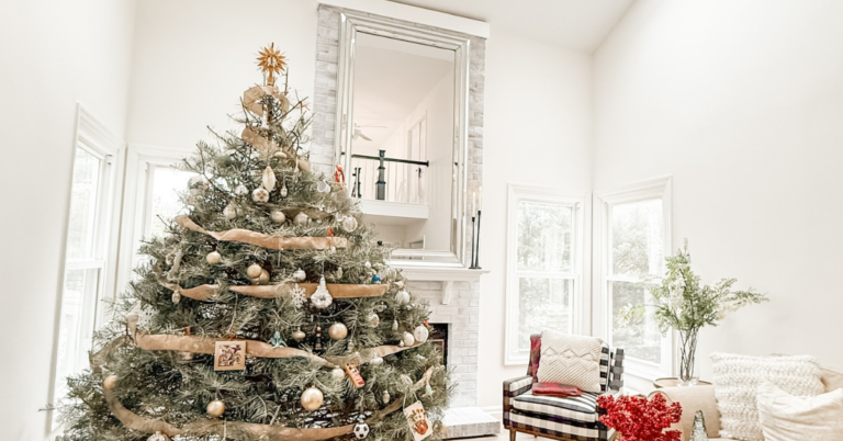 living room decorate for Christmas with large mirror over the fireplace