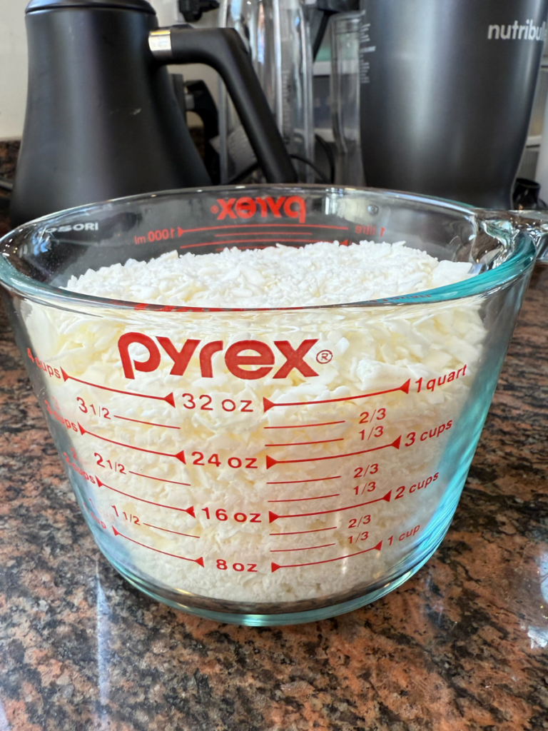 Wax flakes in a measuring cup ready for melting