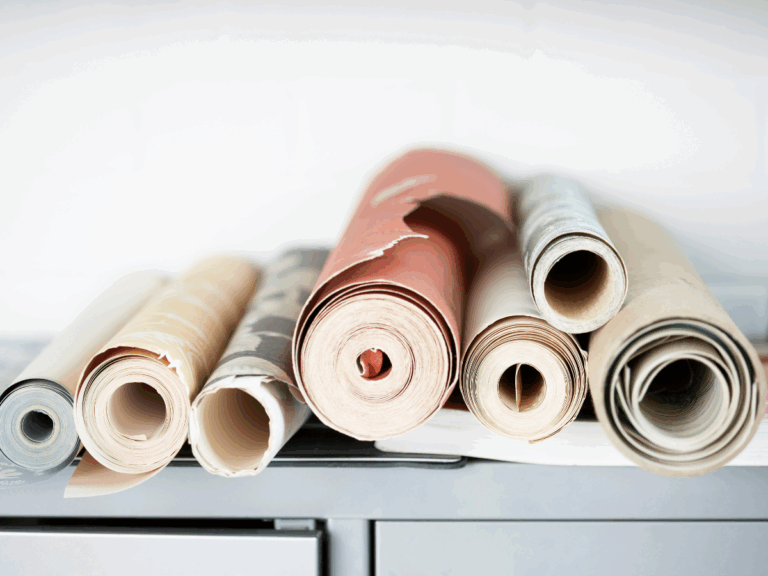 Rolls of colorful wallpaper stacked