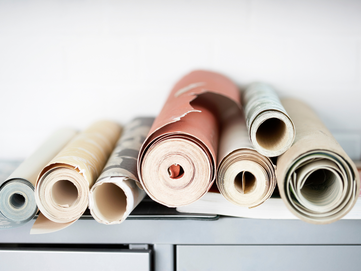 Rolls of colorful wallpaper stacked